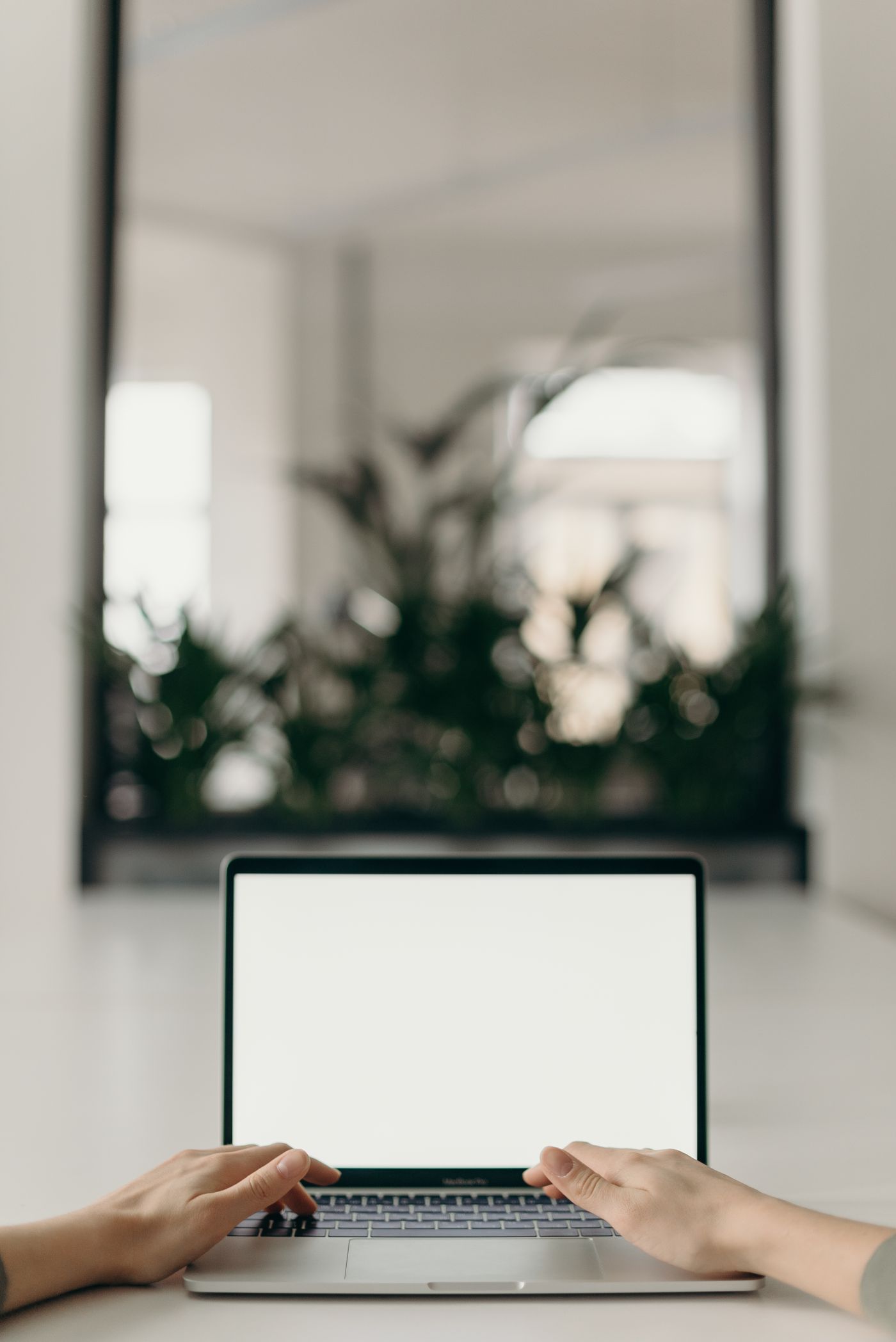 Hands working at a laptop